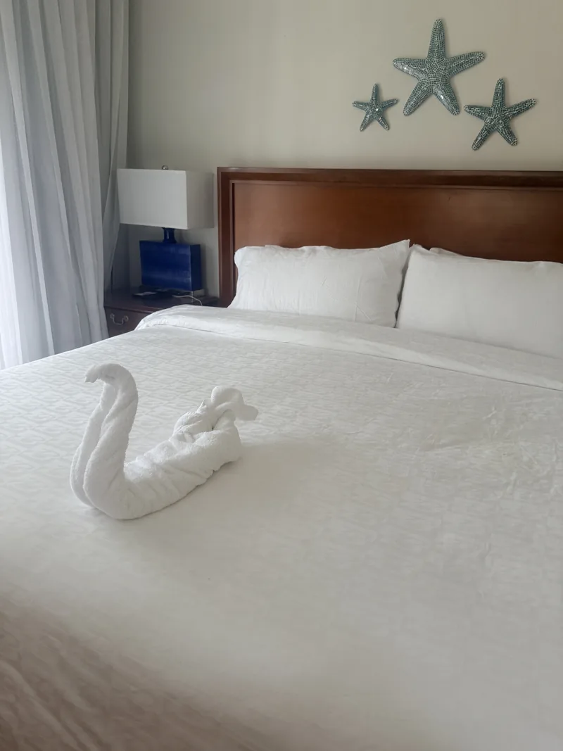 Resort bedroom with a king bed and a towel swan