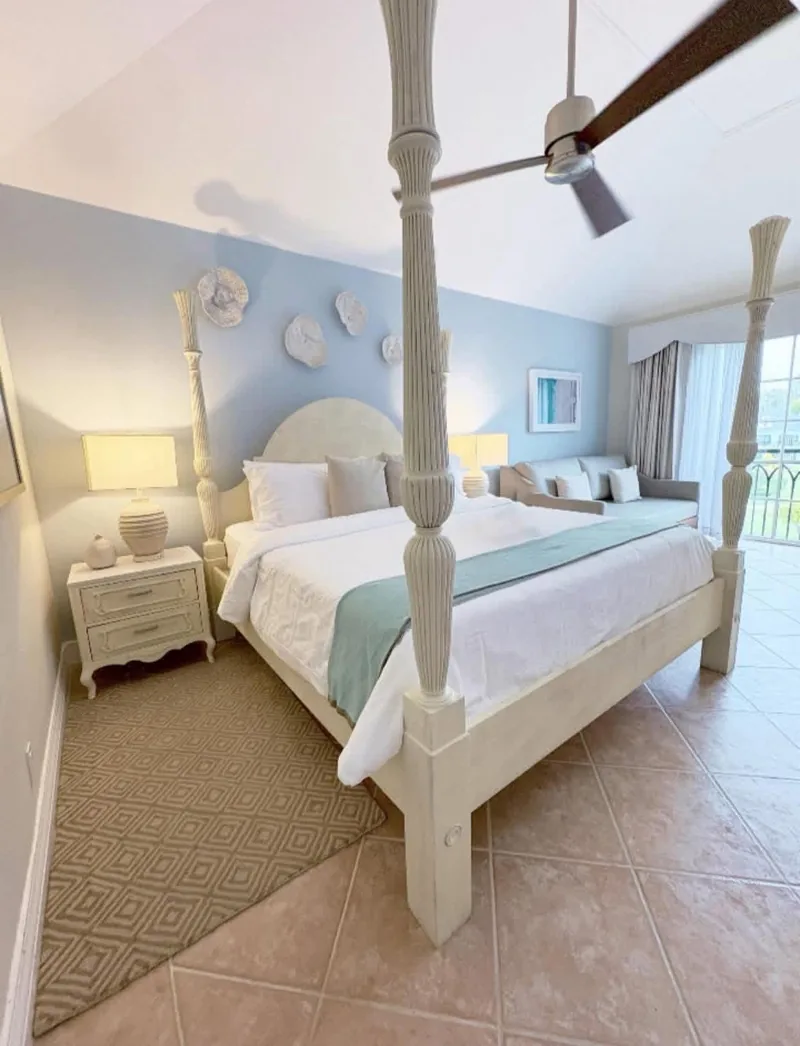 All-inclusive resort bedroom with a king bed and sofa
