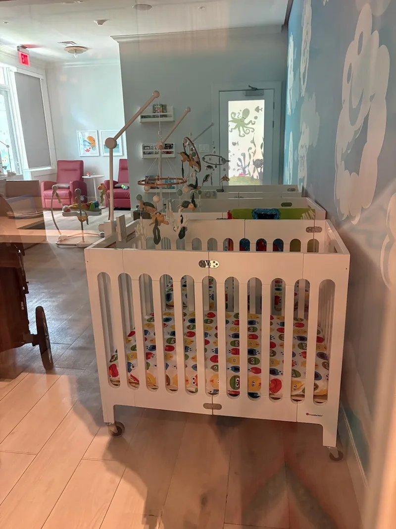 Nursery room with cribs and play equipment at a resort