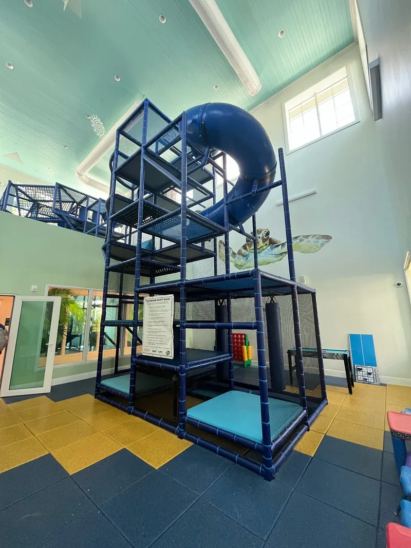 Indoor resort play structure with a blue slide