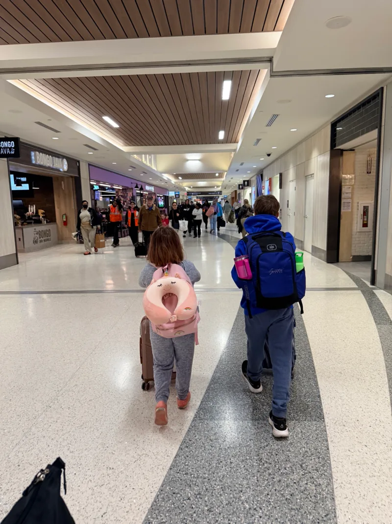 Family traveling through the airport for a Caribbean vacation